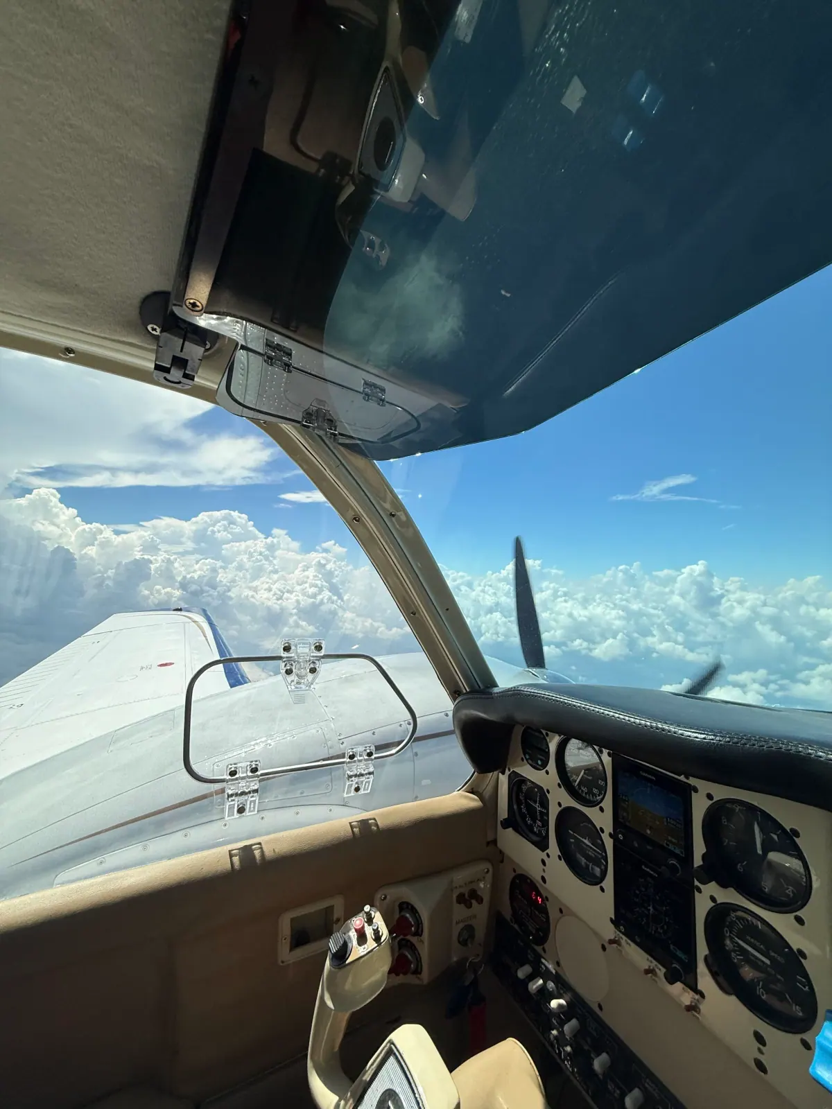View from the Baron B55 cockpit in flight above the clouds