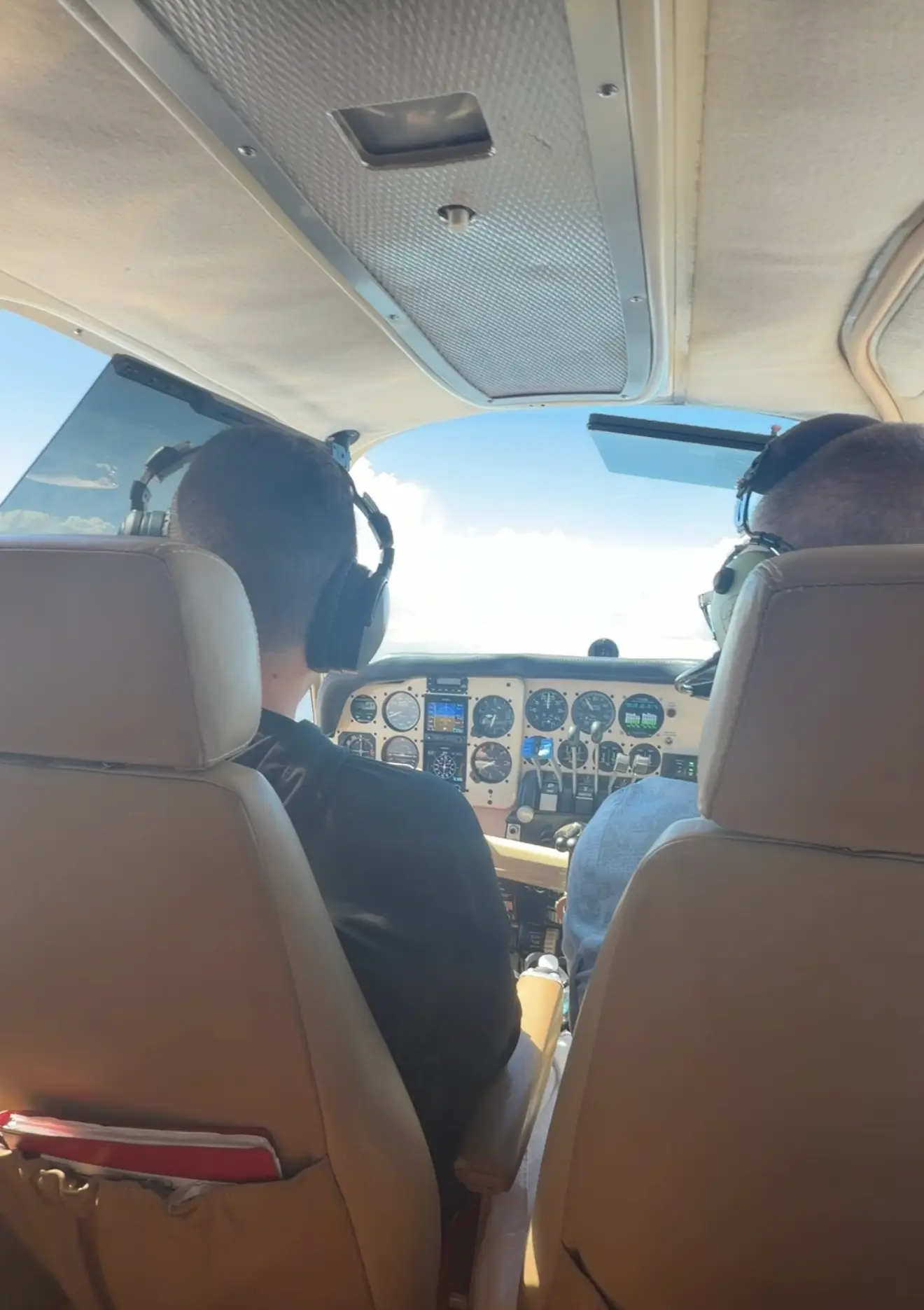 Instructor and student in the cockpit of the Baron B55 during a training flight